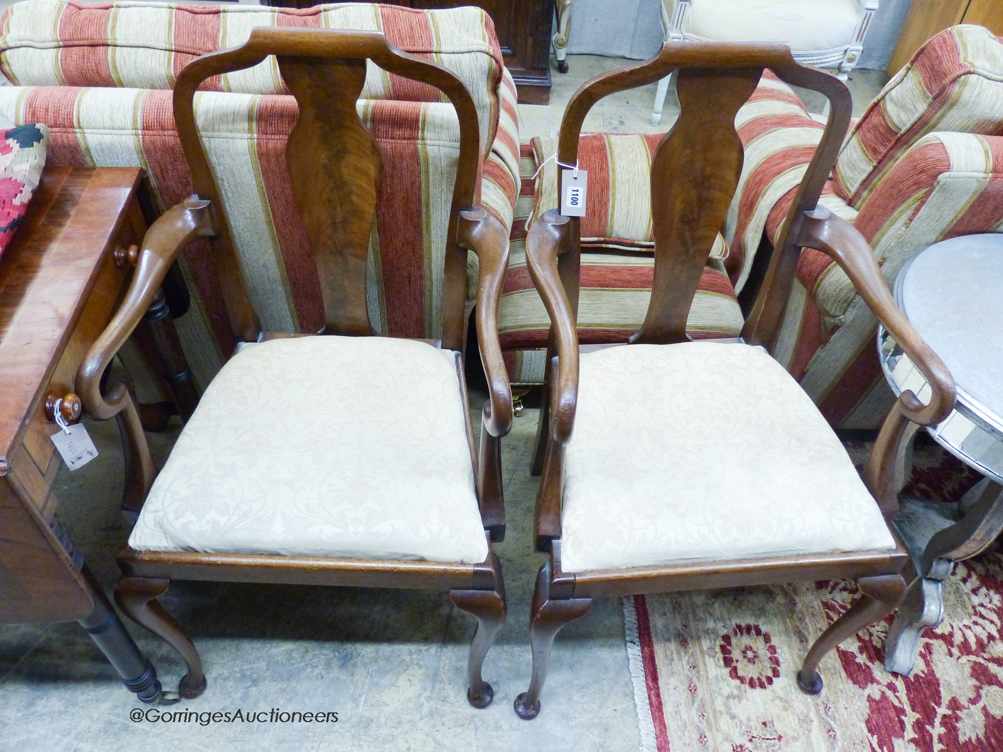 A pair of Queen Anne style mahogany elbow chairs